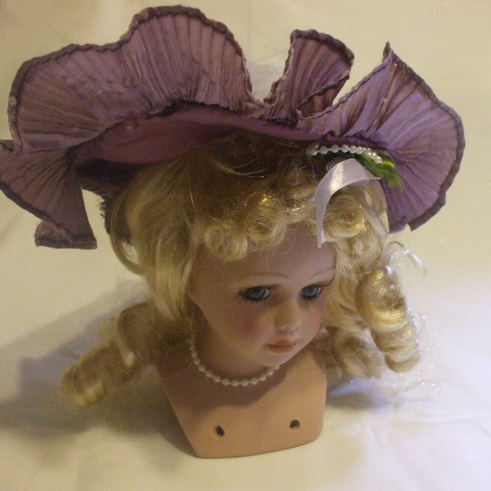 Porcelain purple-hatted blond hair doll head for doll crafters and collectors
